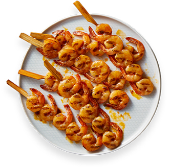 Raw Shrimp Skewers, <div class=“d-block“ style=“color:black“>previously frozen</div> <span>Plain or new honey garlic or</span> <span class=“d-block“> Cajun-style spice marinades</span>