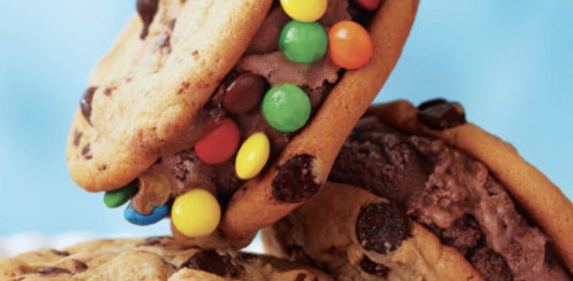 chocolate chip ice cream cookie sandwich with chocolate ice cream and candy-coated chocolates around edges