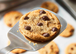 freshly baked chocolate chip cookie on metal spatula