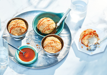 blue platter with three small bowls of faux fried ice cream with hot honey drizzle