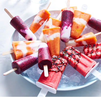 white table with bowl filled with mixed fruit and yogurt ice pops